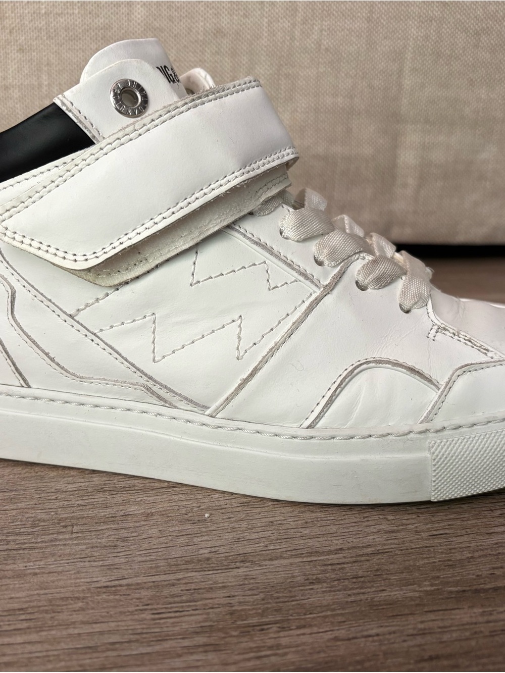 Zadig & Voltaire White Leather High-Top Sneakers with Black Heel Accent.